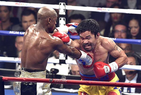 Floyd Mayweather Jr., left, lands a punch on Manny Pacquiao in the fourth round of the WBC Welterweight Championship at the MGM Grand Garden Arena in Las Vegas on Saturday, May 2, 2015. Mayweather won in a unanimous decision. (Wally Skalij/Los Angeles Times/TNS)