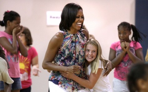 First lady Michelle Obama gets a hug from Savanah Southerland during an unannounced visit to the Blanchard Park YMCA in east Orlando, Florida, Tuesday, July 10, 2012. (Joe Burbank/Orlando Sentinel/MCT)