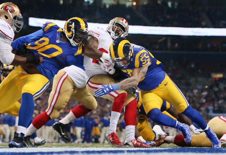 St. Louis Rams defensive tackle Michael Brockers, left, and linebacker James Laurinaitis tackle San Francisco 49ers running back Mike Davis for a one-yard loss and a safety during first quarter action on Sunday, Nov. 1, 2015, at Edward Jones Dome in St. Louis. (Chris Lee/St. Louis Post-Dispatch/TNS)
