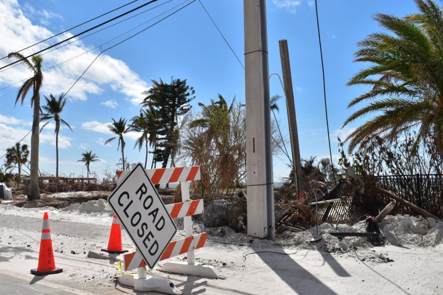 A road closed sign hangs on to the steel holding it up as the road still had water issues after the hurricane.