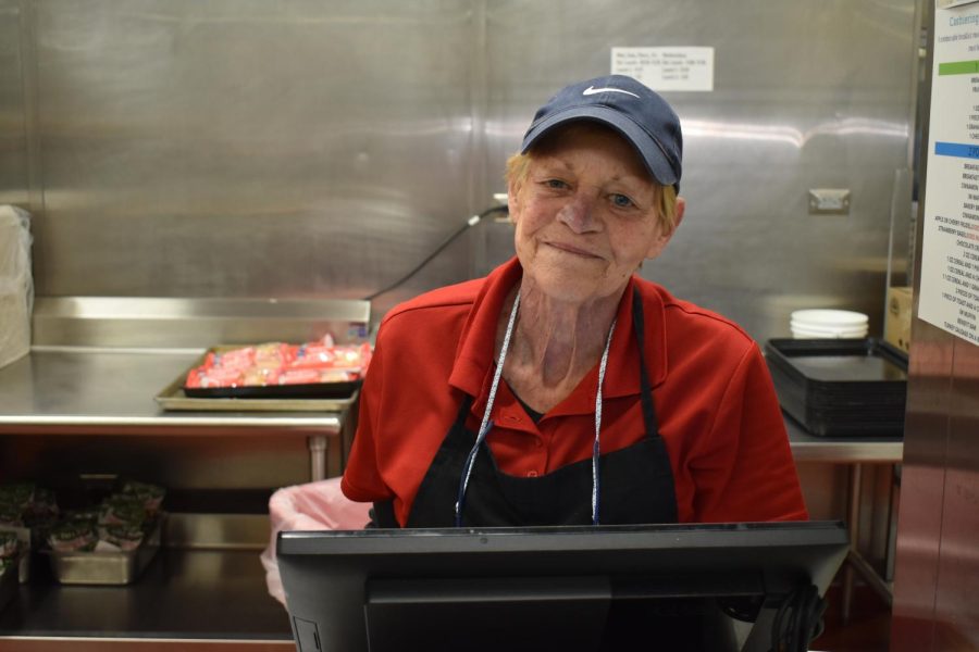 School cafeteria worker Deborah Ronde helps prepare and serves students breakfast in the morning.