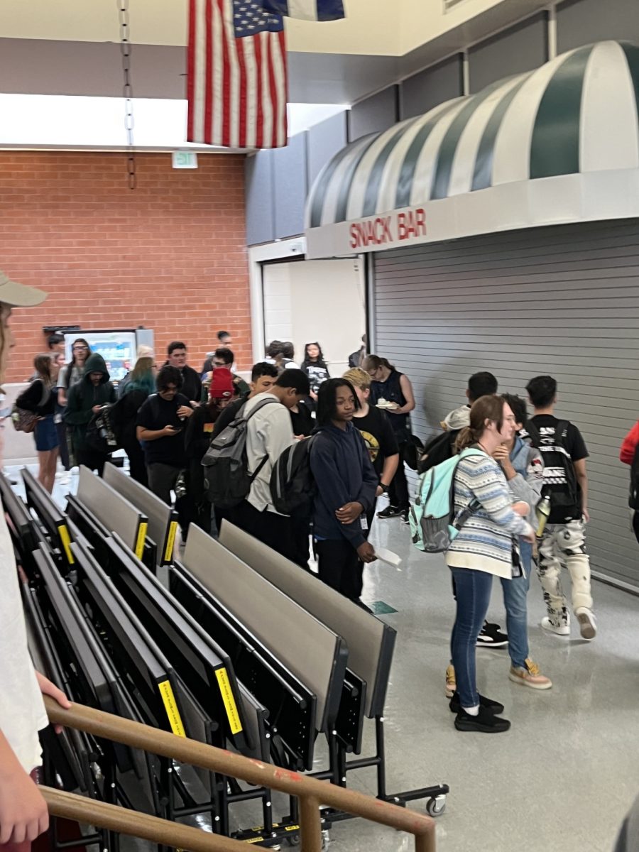 Students wait in a stretched lunch line during peak time.